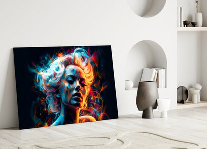 Colorful glass wall art depicting an abstract face with vibrant blue, orange, and red neon-style lighting effects, displayed leaning against a white wall in a minimalist interior.