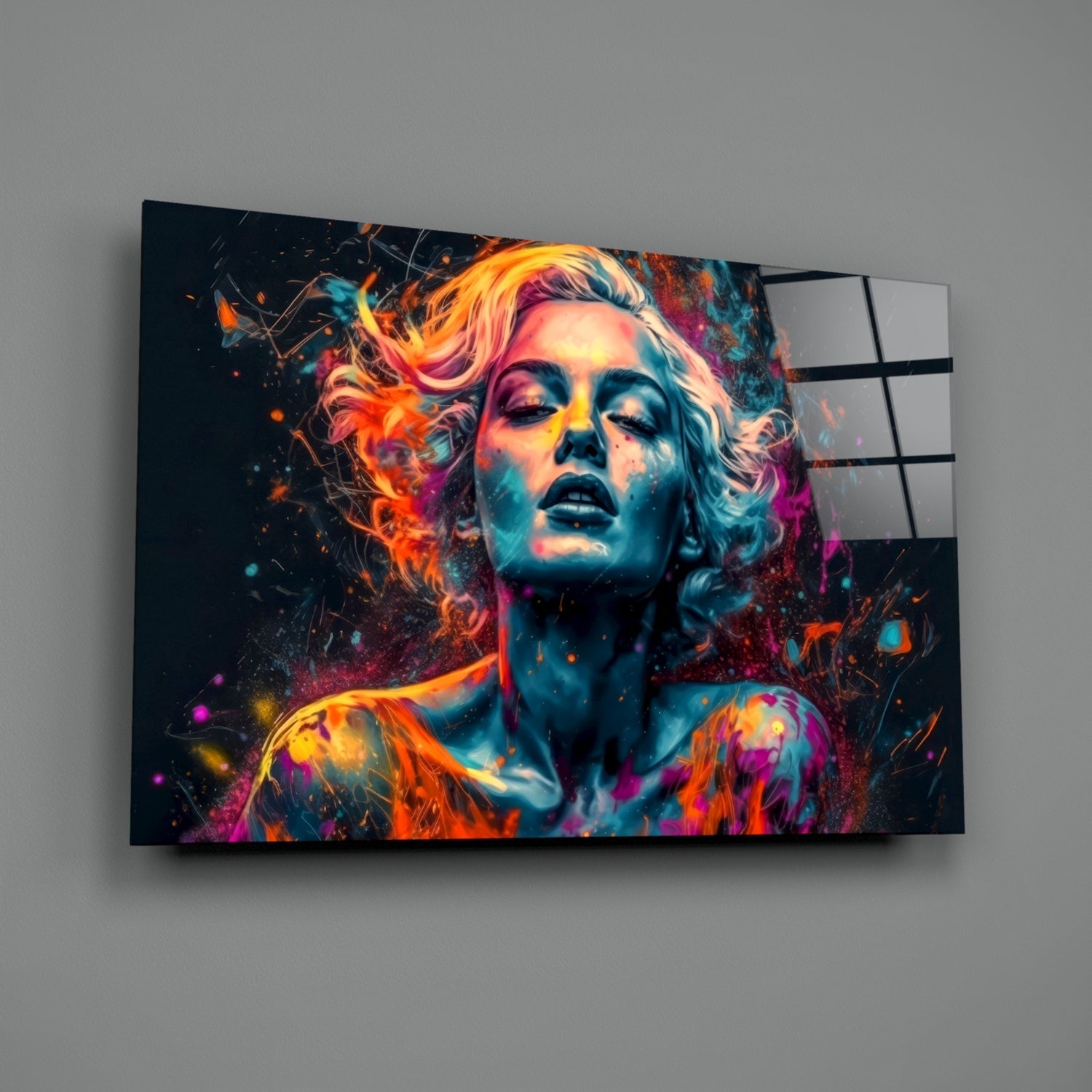 Vibrant glass wall art displaying a colorful portrait of a woman with neon orange, pink, and blue paint effects against a dark background.