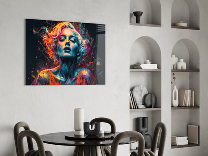 Vibrant neon portrait glass art with colorful abstract splashes displayed above a modern dining table and shelving unit.
