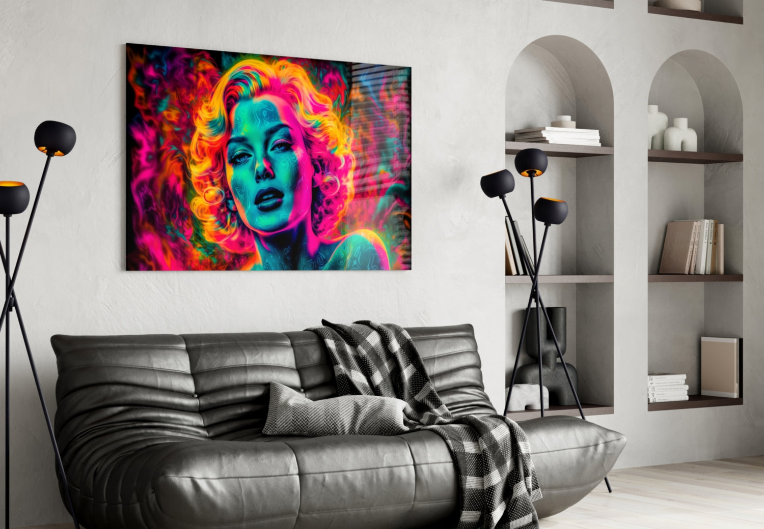 Vibrant neon pop art portrait with magenta, cyan, and yellow tones displayed on white wall above black leather sofa in modern living room.