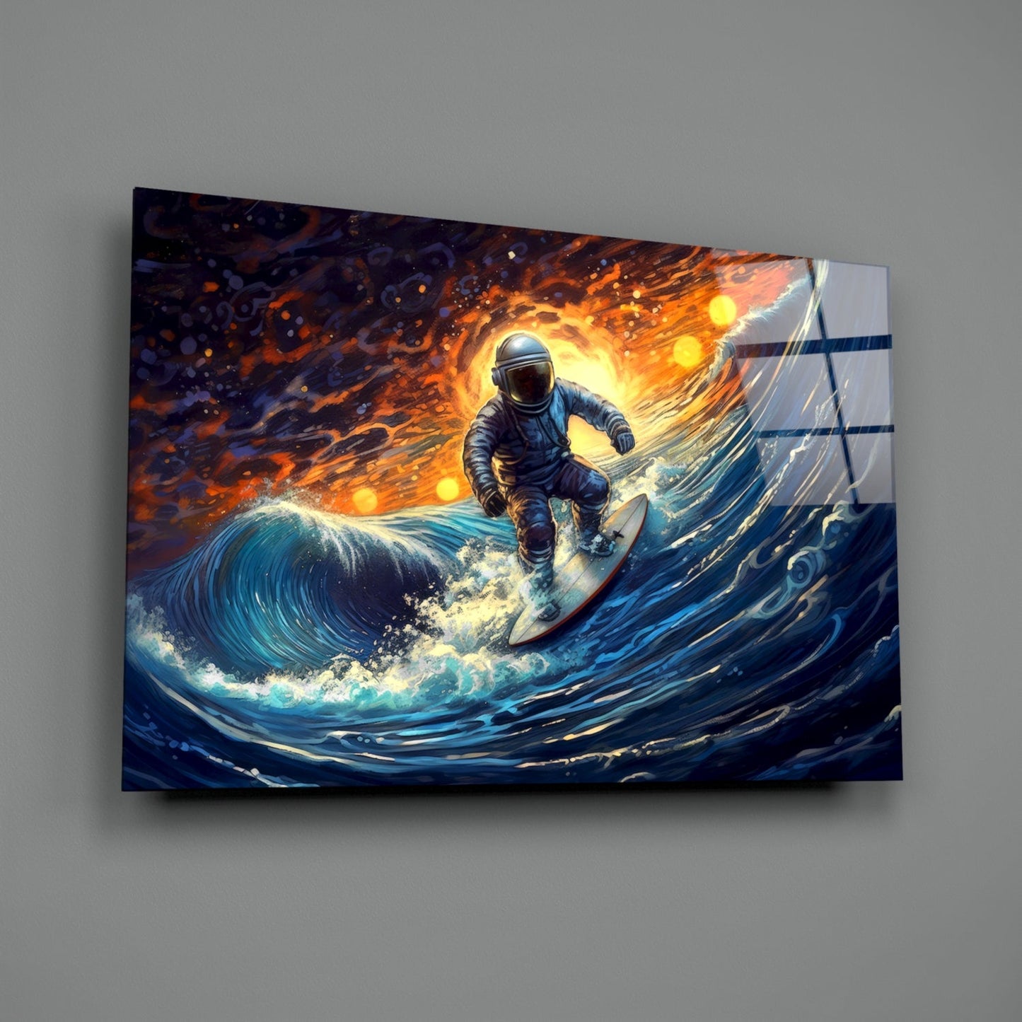 Glass wall art panel displaying an astronaut surfing on a luminous blue wave against an orange and gold fiery sky background, mounted on a gray wall.