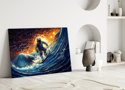 Glass wall art leaning against white wall displays astronaut surfing dynamic blue wave with glowing orange sun.