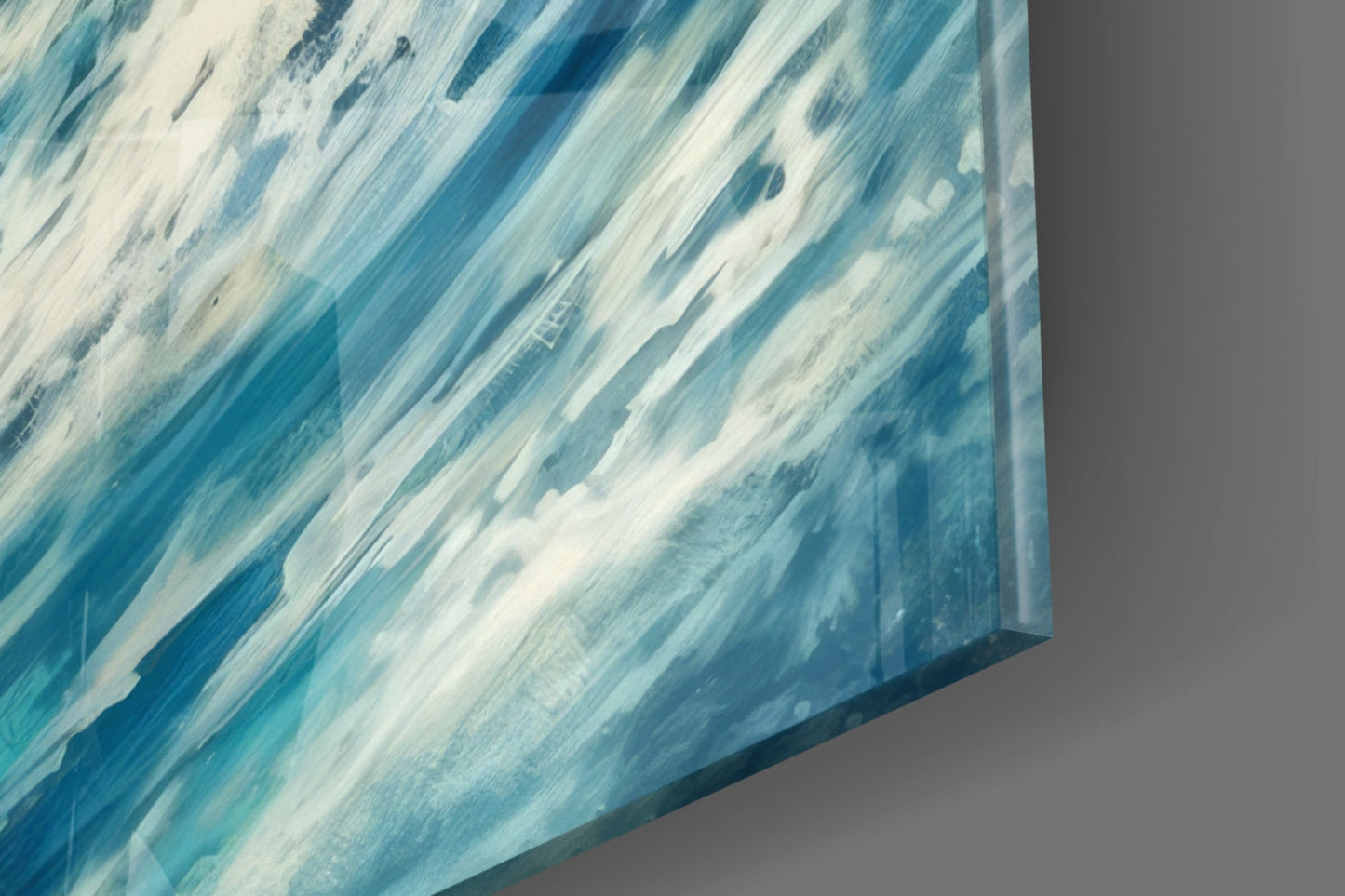 Close-up angled view of glass wall art showing diagonal brushstrokes in shades of blue and white.