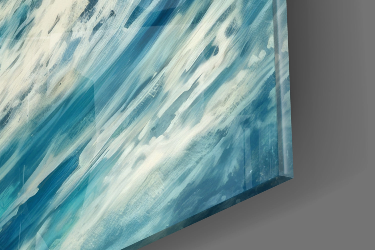 Close-up angled view of glass wall art showing diagonal brushstrokes in shades of blue and white.