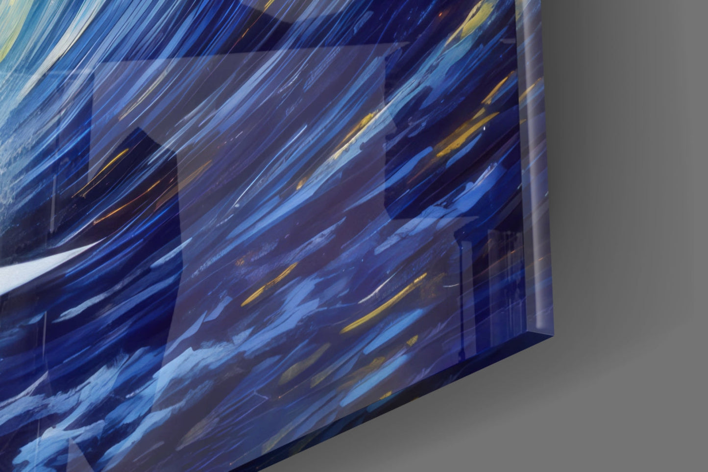 Close-up angled view of blue glass wall art with diagonal streaks in white, gold, and navy tones, showing depth and three-dimensional edge detail.