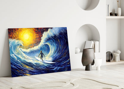 Colorful glass wall art depicting a surfer riding a stylized blue wave with a glowing yellow sun, leaning against a white wall in a minimalist room setting.