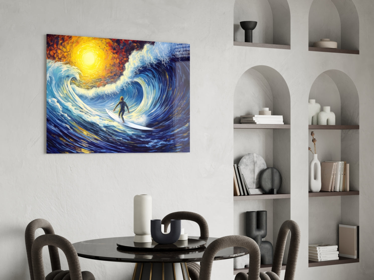 Vibrant glass wall art depicting a surfer riding a swirling blue wave beneath a glowing yellow sun, displayed above a dining table.
