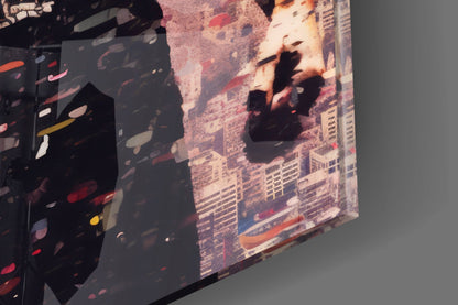 Angled view of glass wall art displaying urban cityscape with silhouetted figures and warm-toned buildings, showing depth and translucent quality.