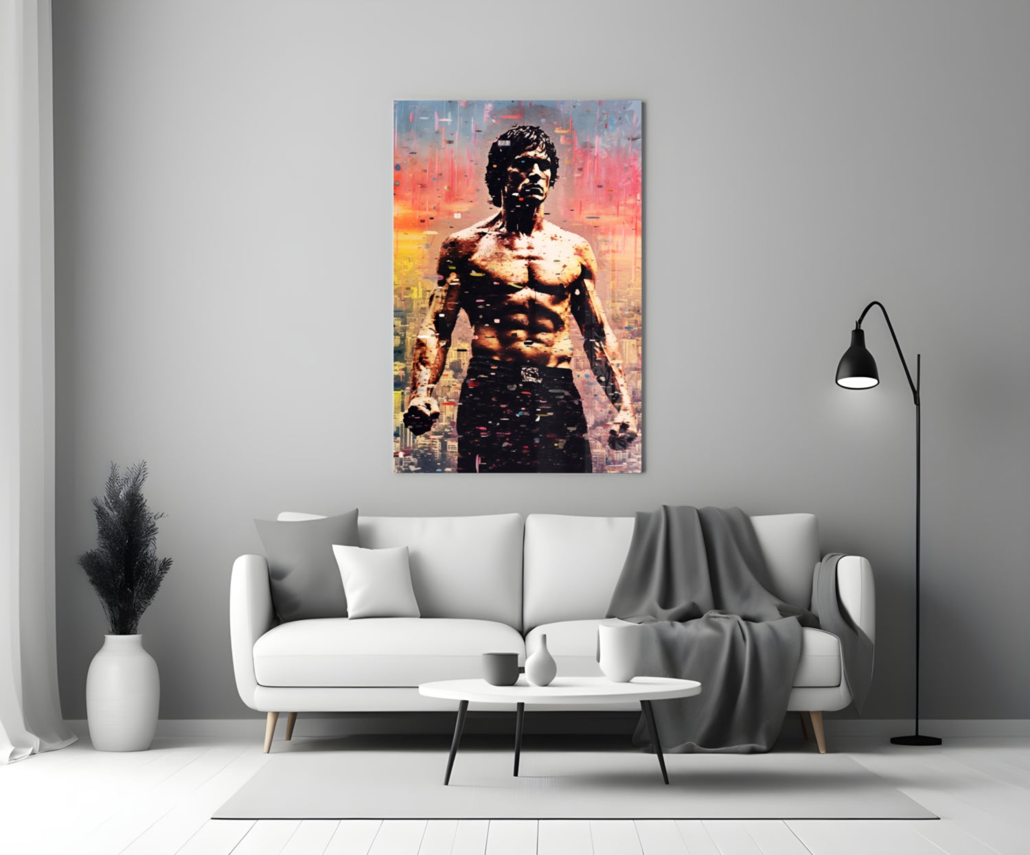 Colorful glass wall art depicting a shirtless muscular man against a pixelated cityscape in warm sunset tones, displayed above a white sofa in a modern living room.