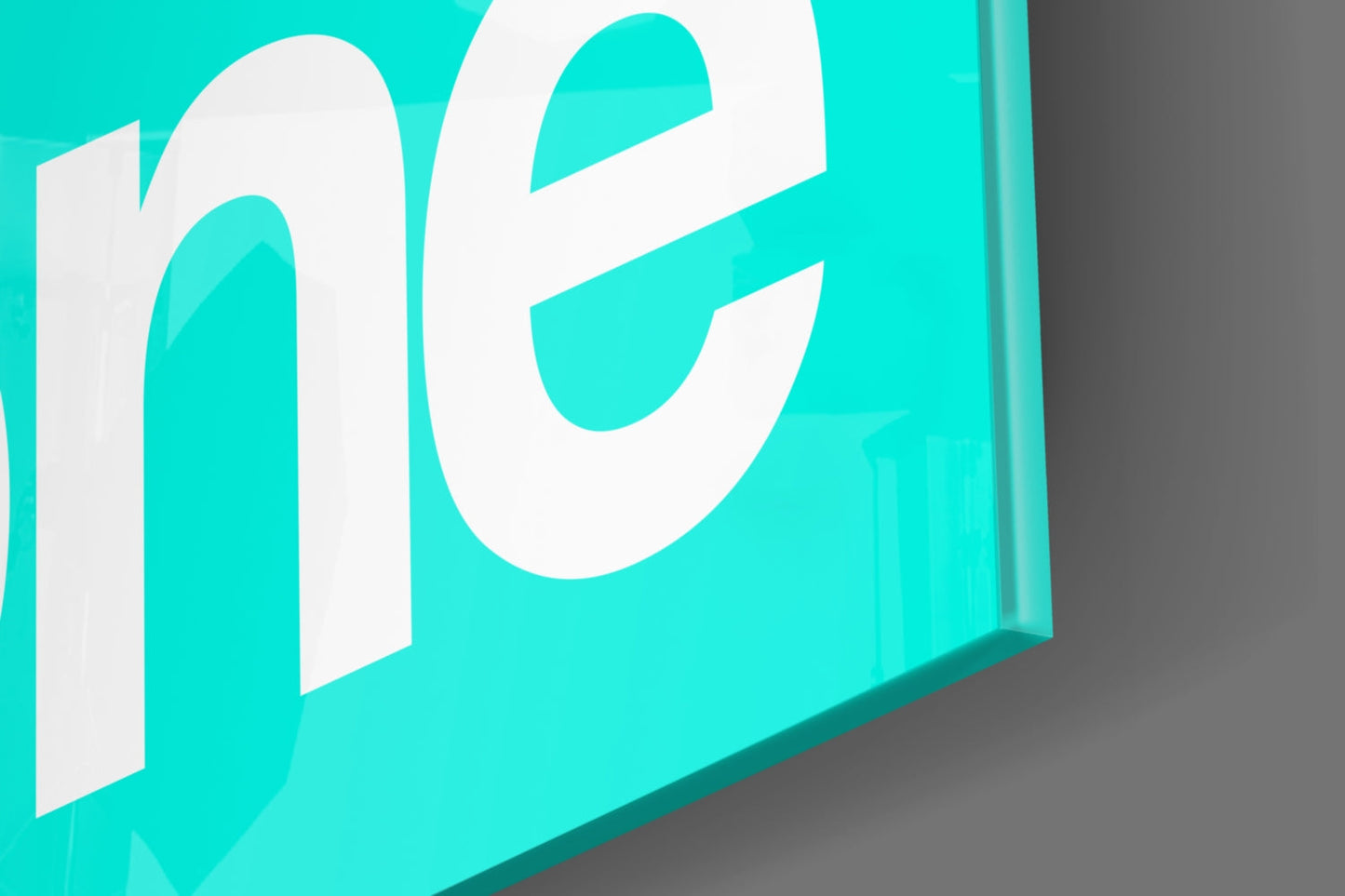 Isometric view of turquoise glass wall art with white "GSD" lettering against gray background.