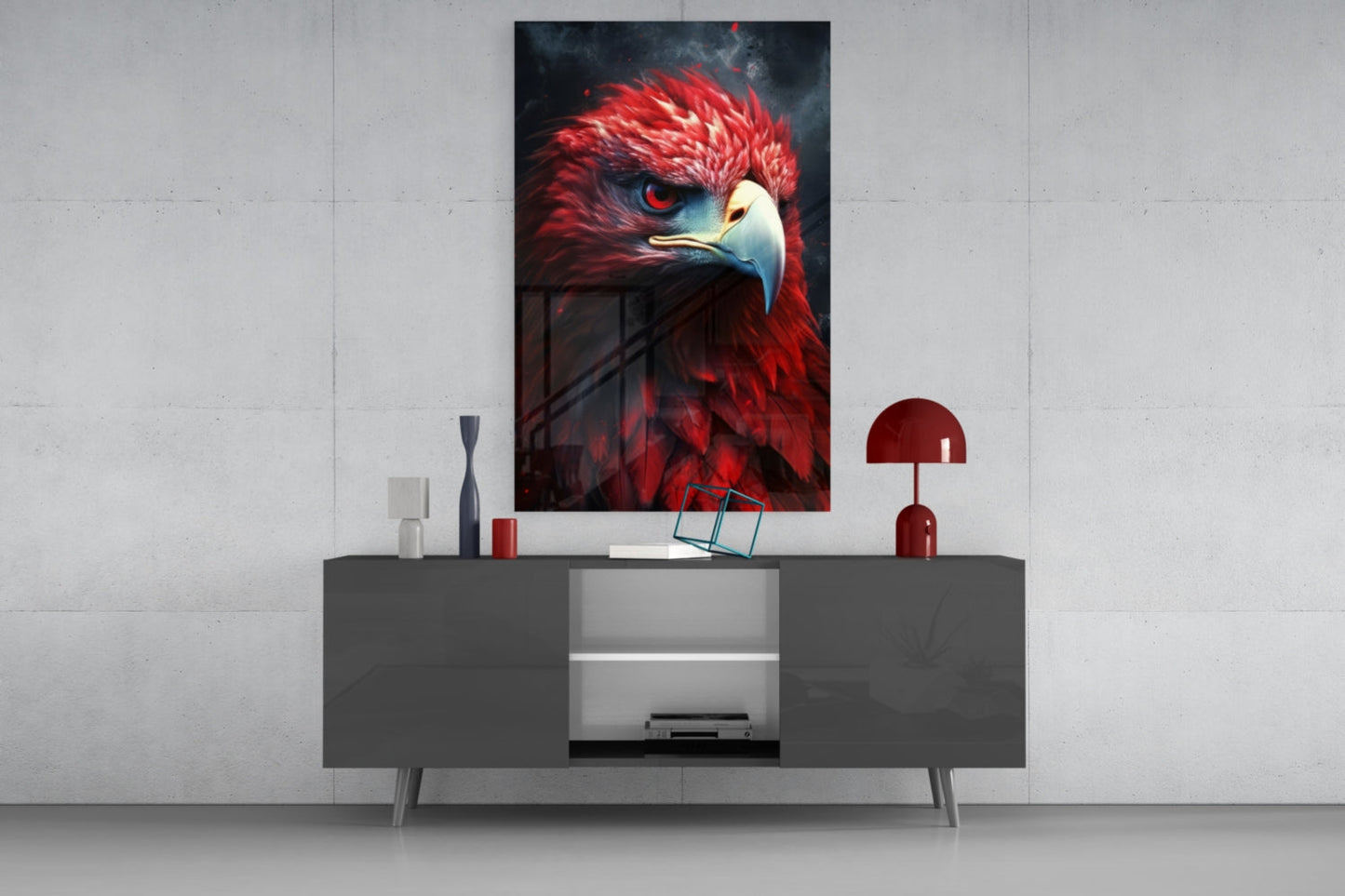 Red eagle glass wall art with crimson and gold plumage displayed above gray media console in modern interior setting.