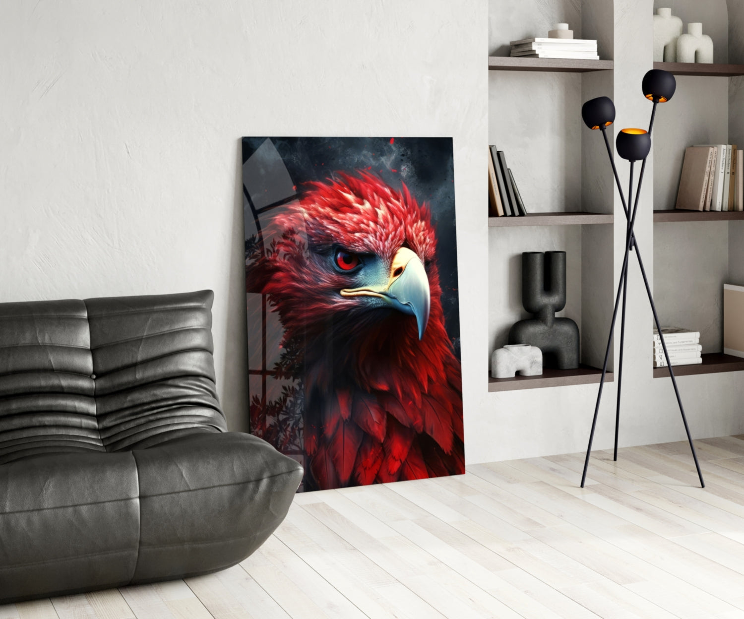 Red eagle glass wall art leaning against white wall in modern living room with gray sofa and shelving.