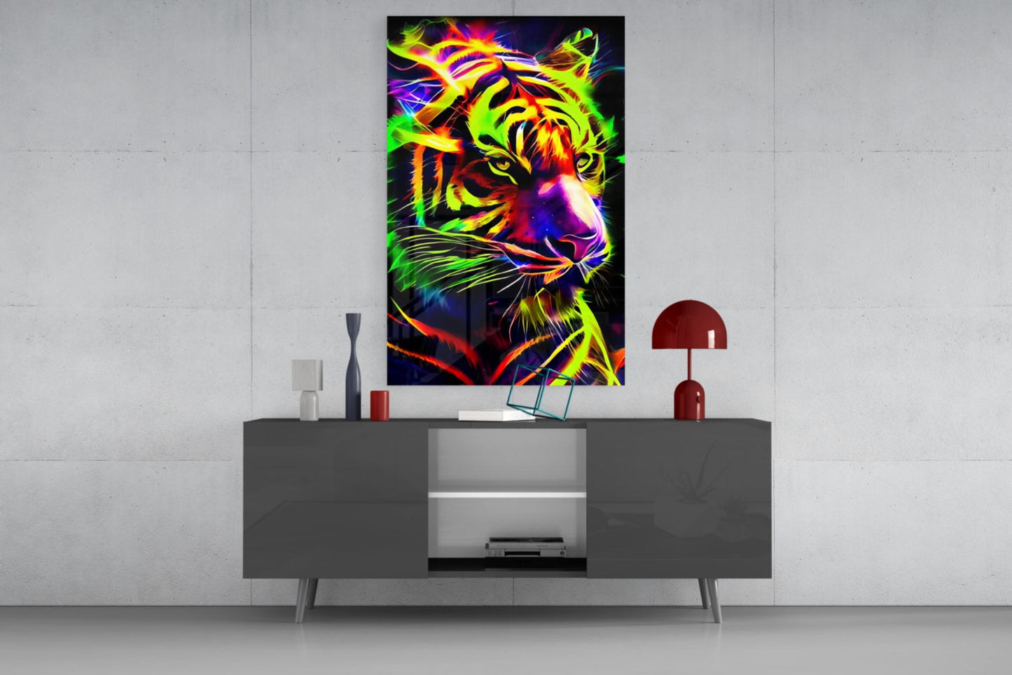 Vibrant neon tiger glass wall art displayed above gray modern sideboard with red lamp and decorative objects.