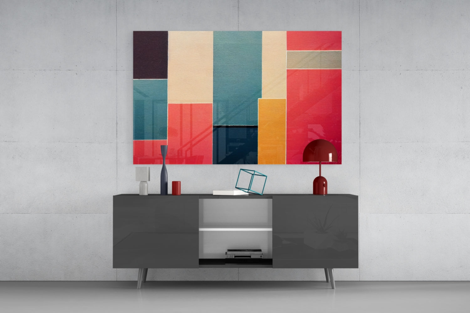 Colorful geometric glass wall art featuring red, teal, cream, and navy rectangles displayed above a dark media console in a modern living room setting.