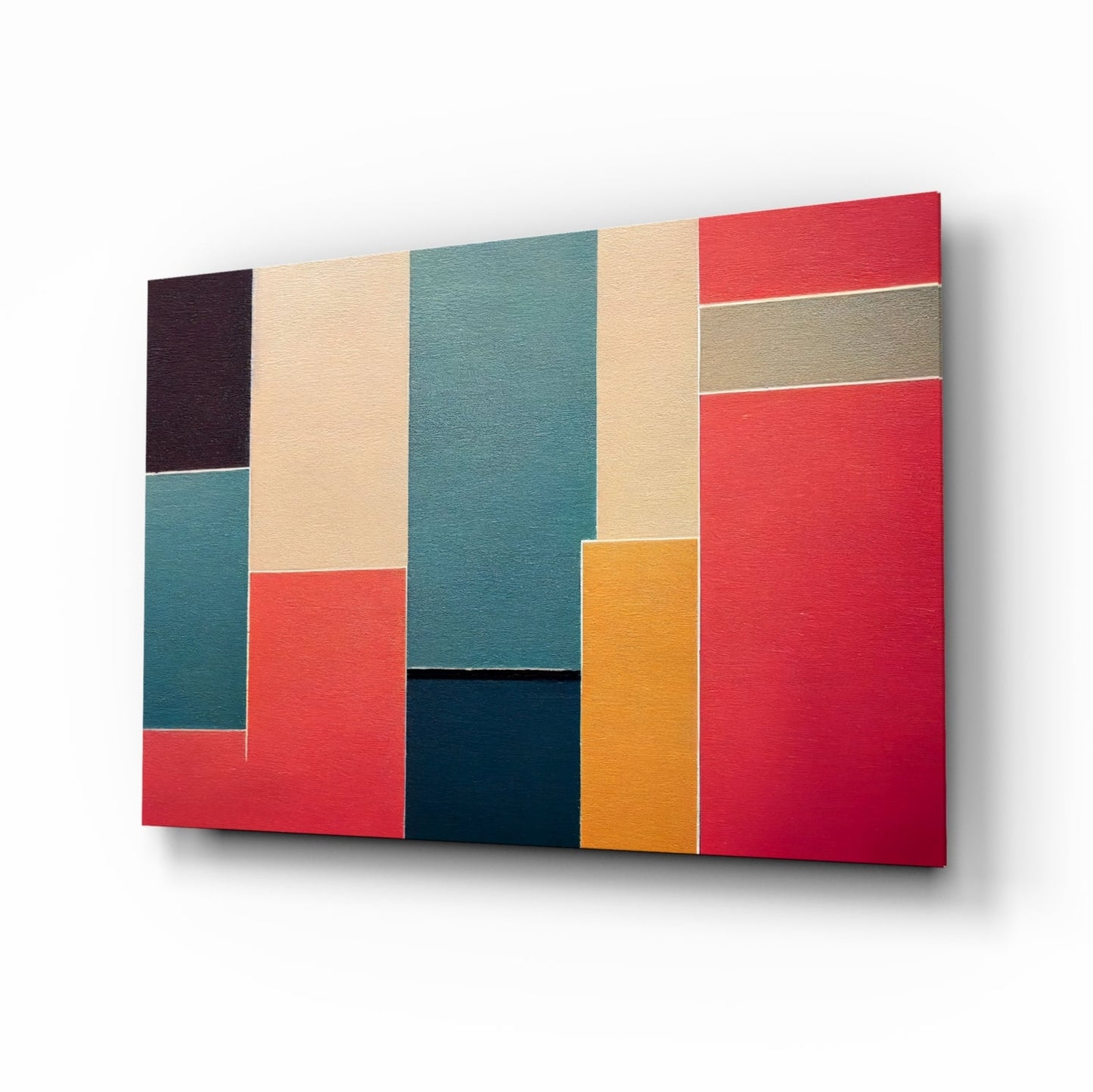 Angled three-quarter view of a textured glass wall art panel featuring a geometric patchwork design in red, teal, cream, dark blue, tan, orange, and dark brown rectangles.