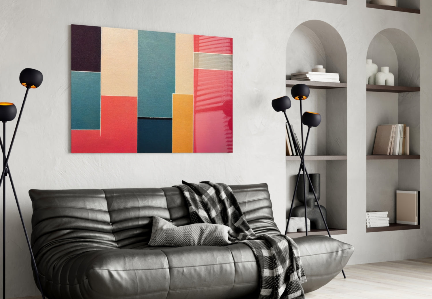 Colorful abstract geometric glass wall art in teal, red, orange, and cream displayed above a black leather sofa in a modern living room.