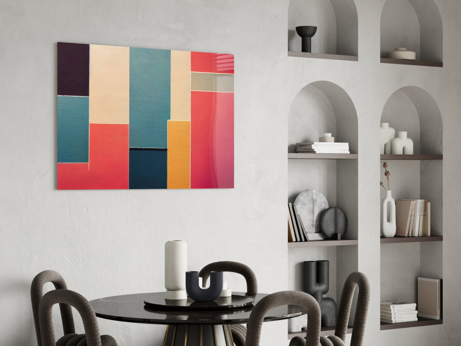 Colorful geometric glass art panel with teal, red, cream, orange, and navy rectangles displayed above a black round dining table in a modern interior.