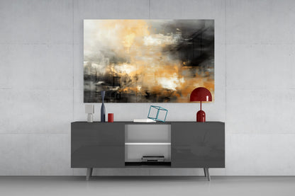 Modern living room setup featuring abstract glass wall art with golden and dark tones displayed above a dark gray media console with red decorative accessories.
