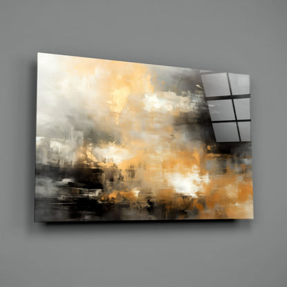 Abstract glass wall art panel with golden and gray brushstroke design mounted on gray wall, angled perspective view.