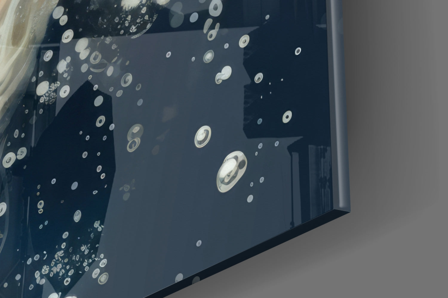 Close-up angled view of glass wall art displaying white and gray angelfish silhouettes scattered across dark background.