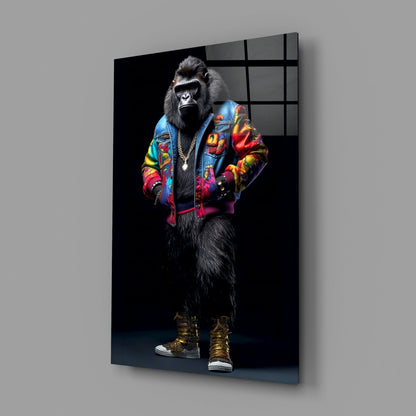 Glass wall art featuring a gorilla in a colorful embroidered jacket and gold boots against black background, displayed at an angle.