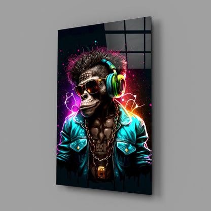 Angled view of glass wall art featuring a neon-lit monkey wearing sunglasses and colorful headphones against a dark background with vibrant pink, cyan, and orange lighting effects.