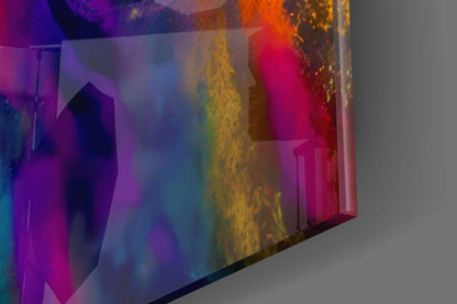 Angled close-up view of translucent glass wall art displaying vibrant rainbow gradient colors from purple through blue, yellow, orange, and magenta against neutral background.