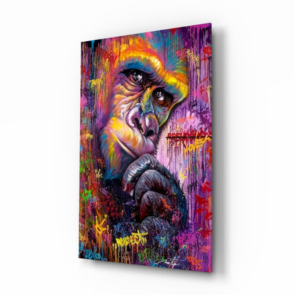 Angled view of colorful glass wall art featuring a vibrant primate portrait with rainbow drips and graffiti-style markings.