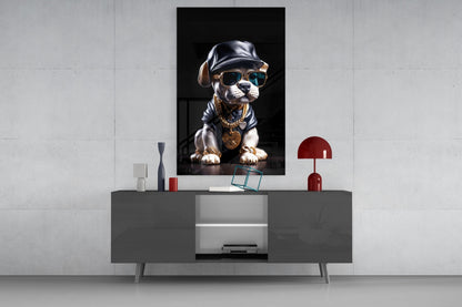 Stylized puppy wearing sunglasses, leather cap, and gold chain displayed as framed wall art above gray media console in modern interior.