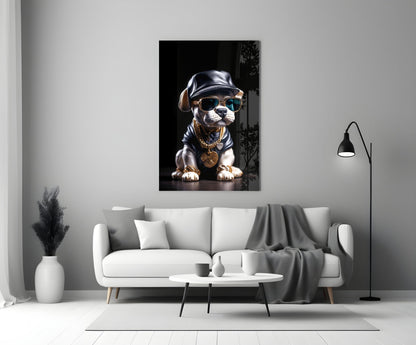 Stylized puppy wearing sunglasses, leather cap, and gold chain necklace displayed on white living room wall above sofa.