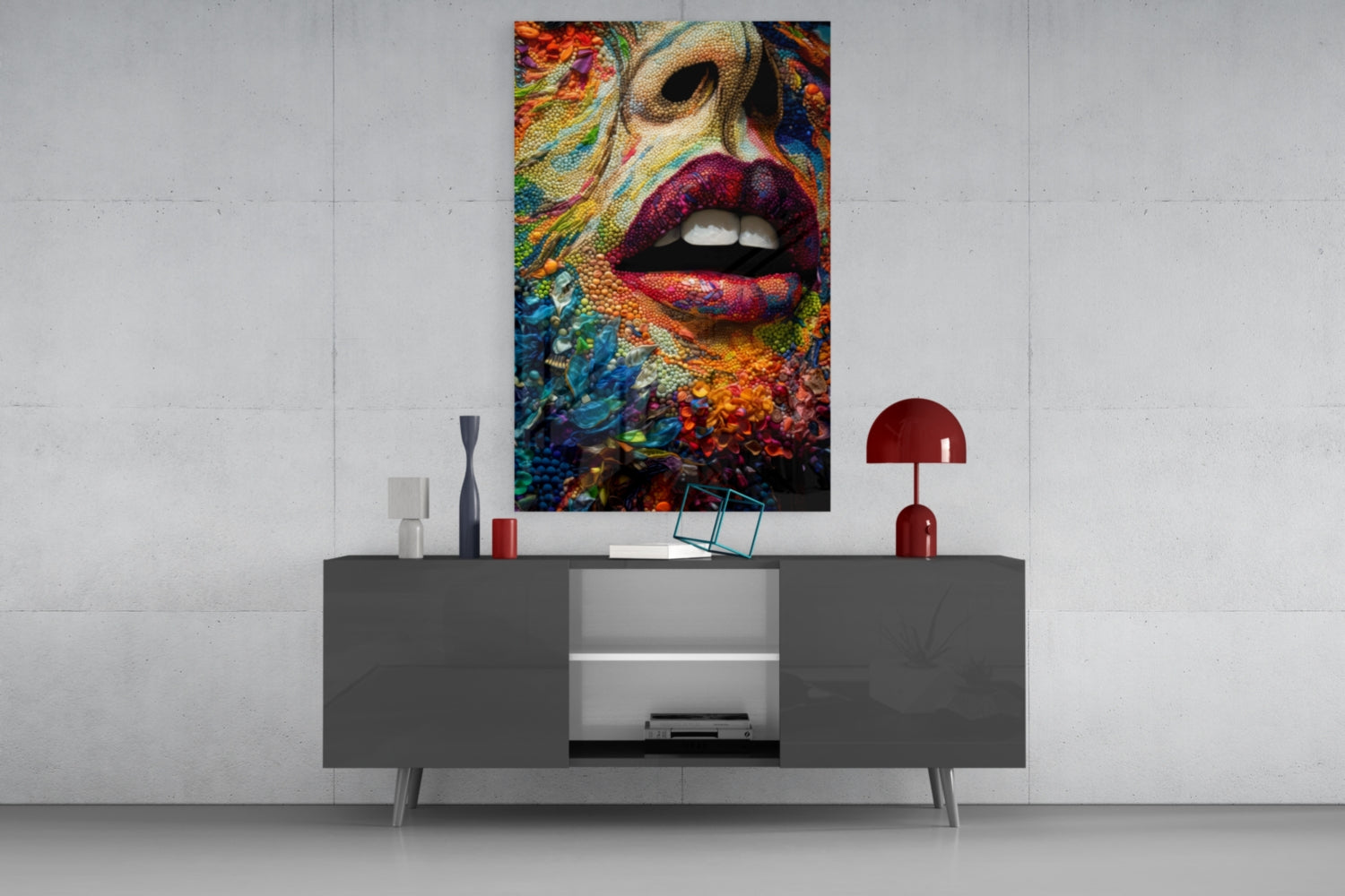 Vibrant colorful glass wall art depicting lips and abstract floral patterns displayed above a modern gray console table.