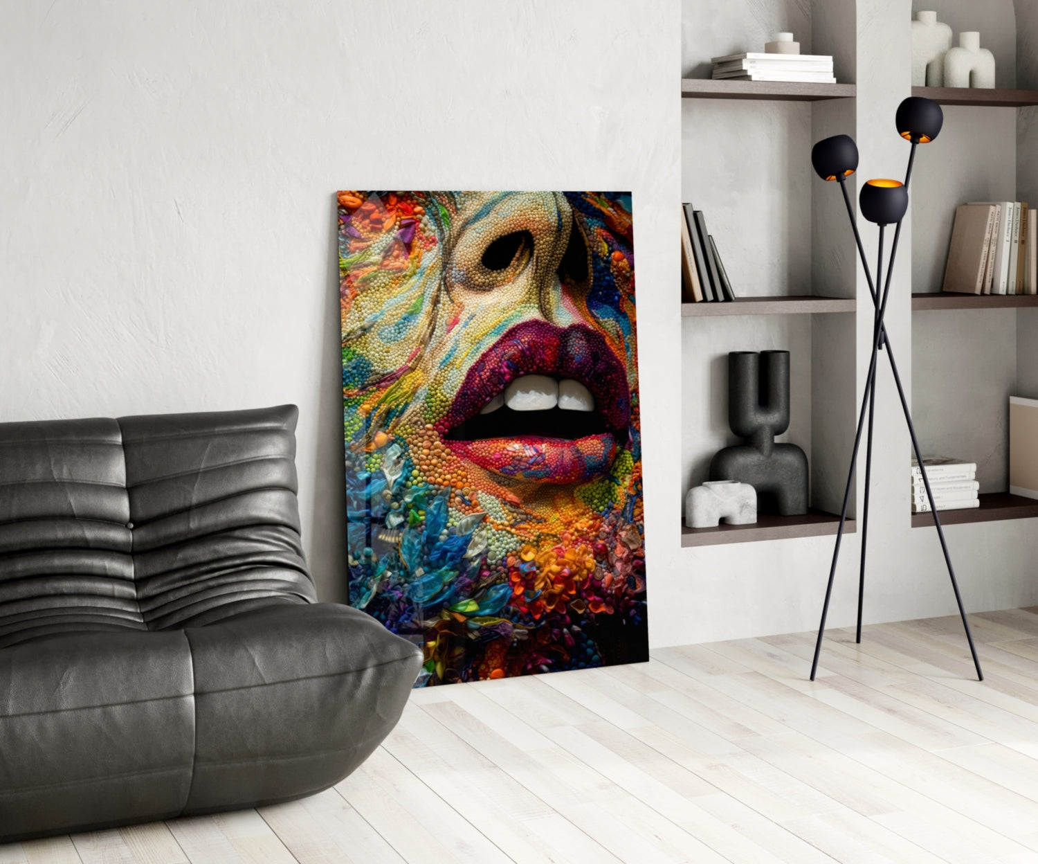 Colorful glass wall art depicting vibrant lips and textured floral patterns displayed in a modern living room with gray sofa and shelving.