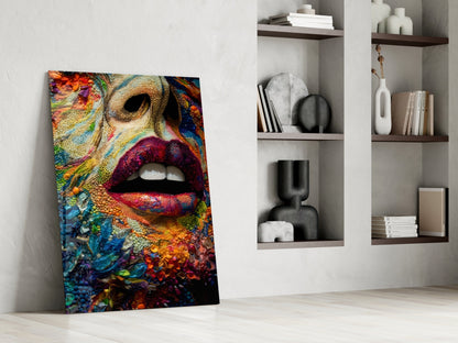 Colorful glass wall art leaning against white wall displays vibrant lips surrounded by textured floral and coral reef patterns in rainbow hues.