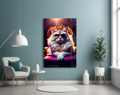 Regal cat wearing sunglasses and crown on glass wall art displayed in modern room with teal walls and white furniture.