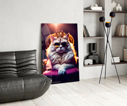 Glass wall art depicting a regal cat wearing sunglasses and crown with golden fire aura, displayed in modern living room setting.