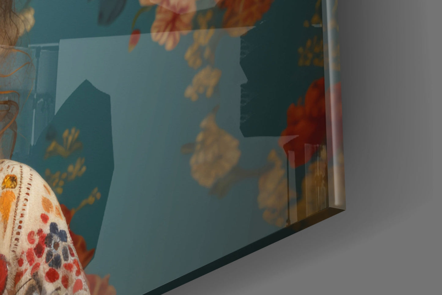 Close-up angled view of glass wall art with teal background, golden botanical motifs, and decorative patterned fabric visible at left edge.