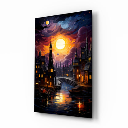 Angled view of glass wall art depicting a glowing moon over a moonlit canal city with illuminated buildings and boats, displayed against white background.
