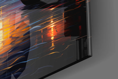 Angled side view of glass wall art displaying flowing orange, yellow, and blue streaks against dark background with gray wall visible.