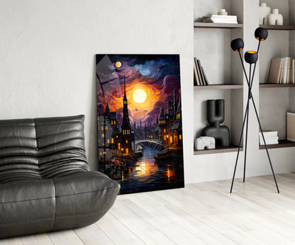 Moonlit cityscape glass art leaning against white wall beside gray leather chair and floor lamp.