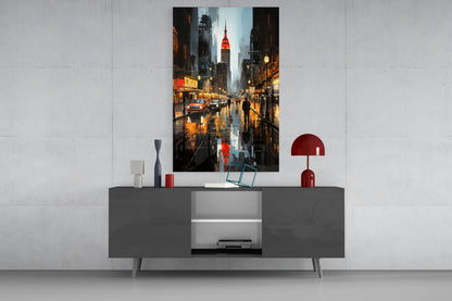 Modern living room setup showing City Night Glass Wall Art depicting rainy New York street scene with illuminated buildings and Chrysler Building, displayed above gray media console with red decorative accessories.