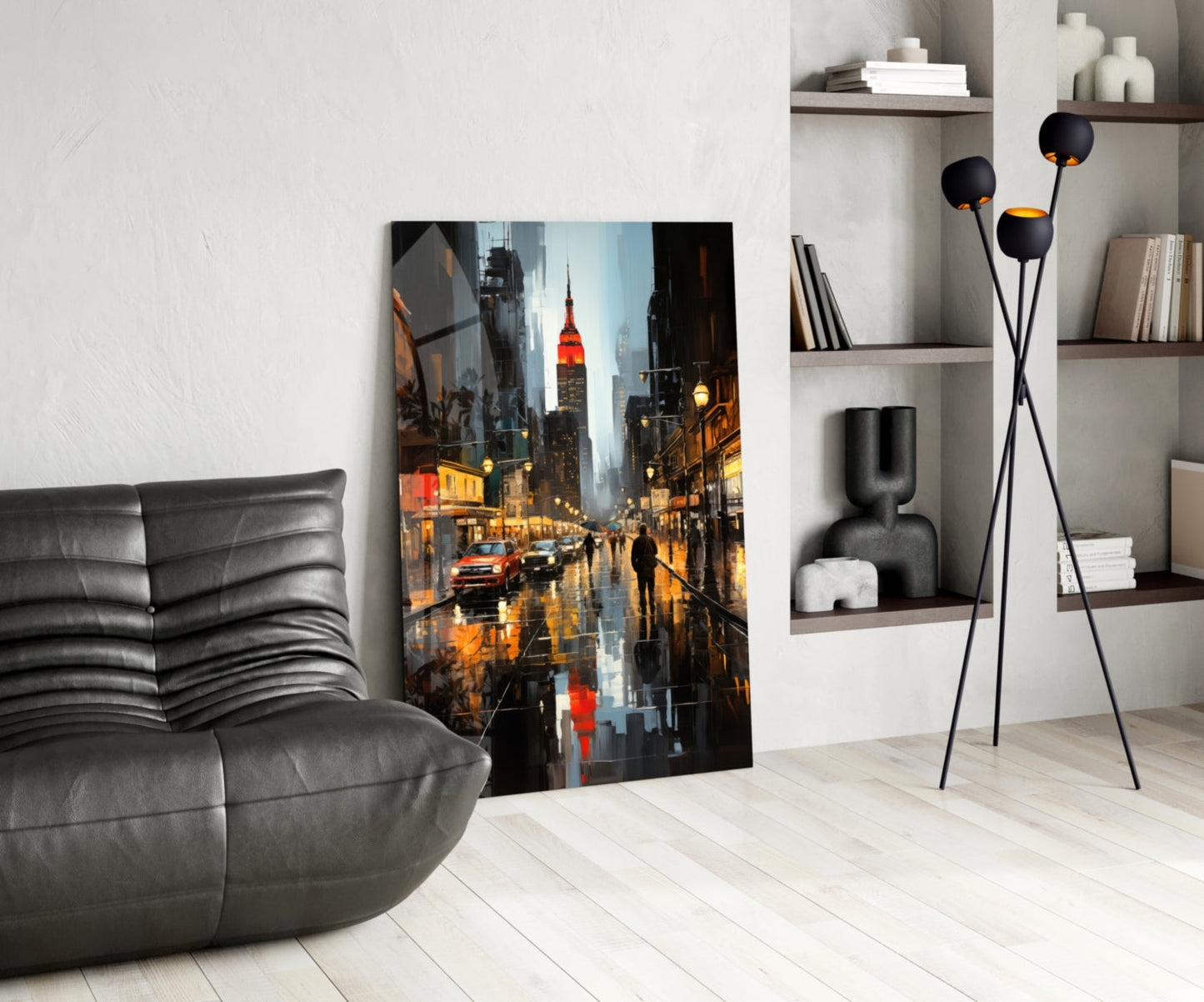 Modern living room with gray leather chair, rainy New York City street scene glass art leaning against white wall, black floor lamp, and shelving unit.