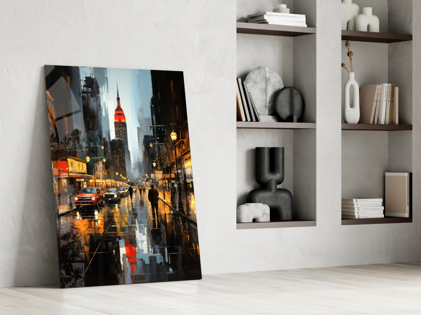 Glass wall art leaning against white wall displays rainy city street with illuminated Empire State Building and yellow taxi cab.