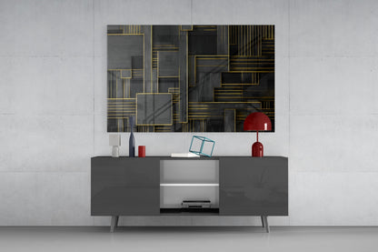 Modern living room setup featuring geometric glass wall art with gold lines and dark tones above a dark gray media console with red decorative accents.