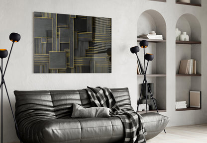 Black and gold geometric glass wall art displayed above a gray leather sofa in a modern living room interior.