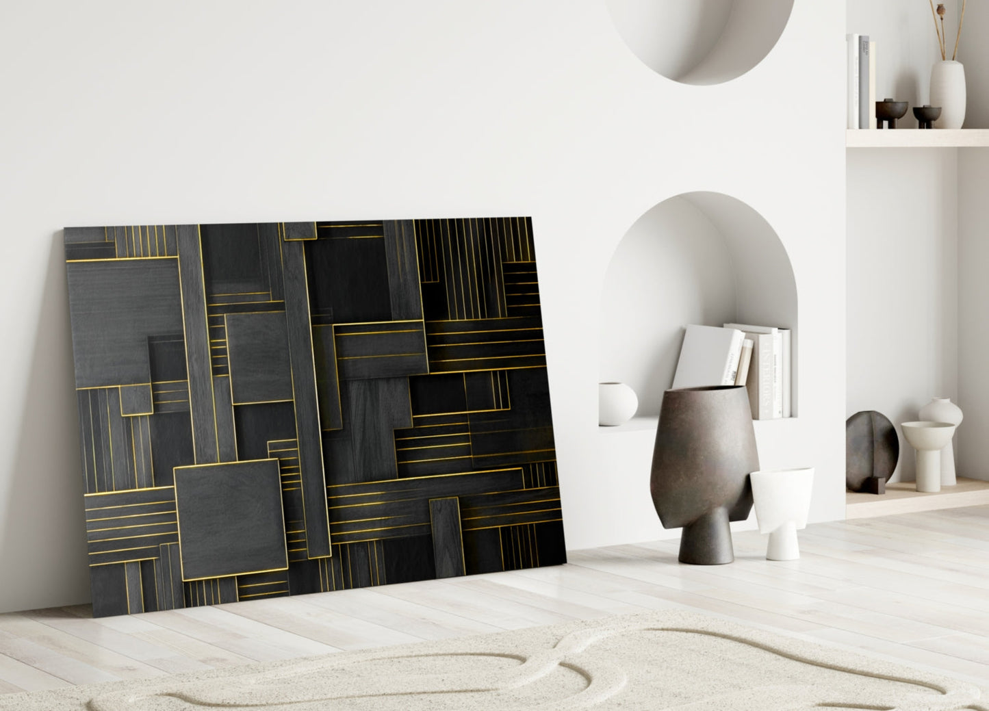 Black and gold geometric glass wall art leaning against white wall in modern interior display setting.