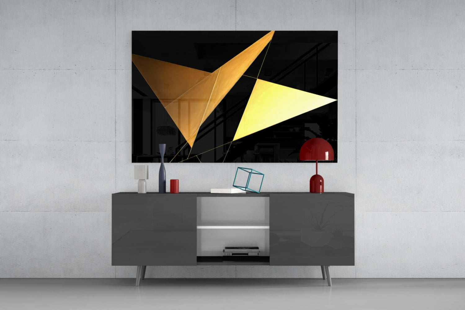Modern living room setup displaying geometric glass wall art with gold and yellow triangular shapes mounted above gray media console.