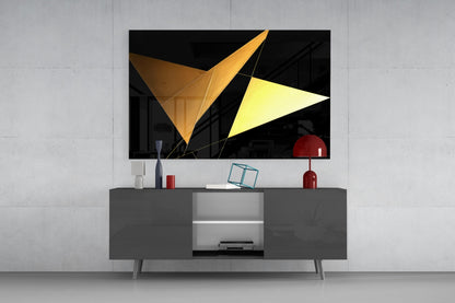Modern living room setup displaying geometric glass wall art with gold and yellow triangular shapes mounted above gray media console.