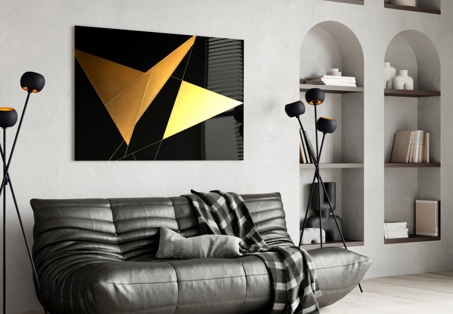 Black and yellow geometric glass wall art with triangular shapes displayed above a gray leather sofa in a modern living room interior.