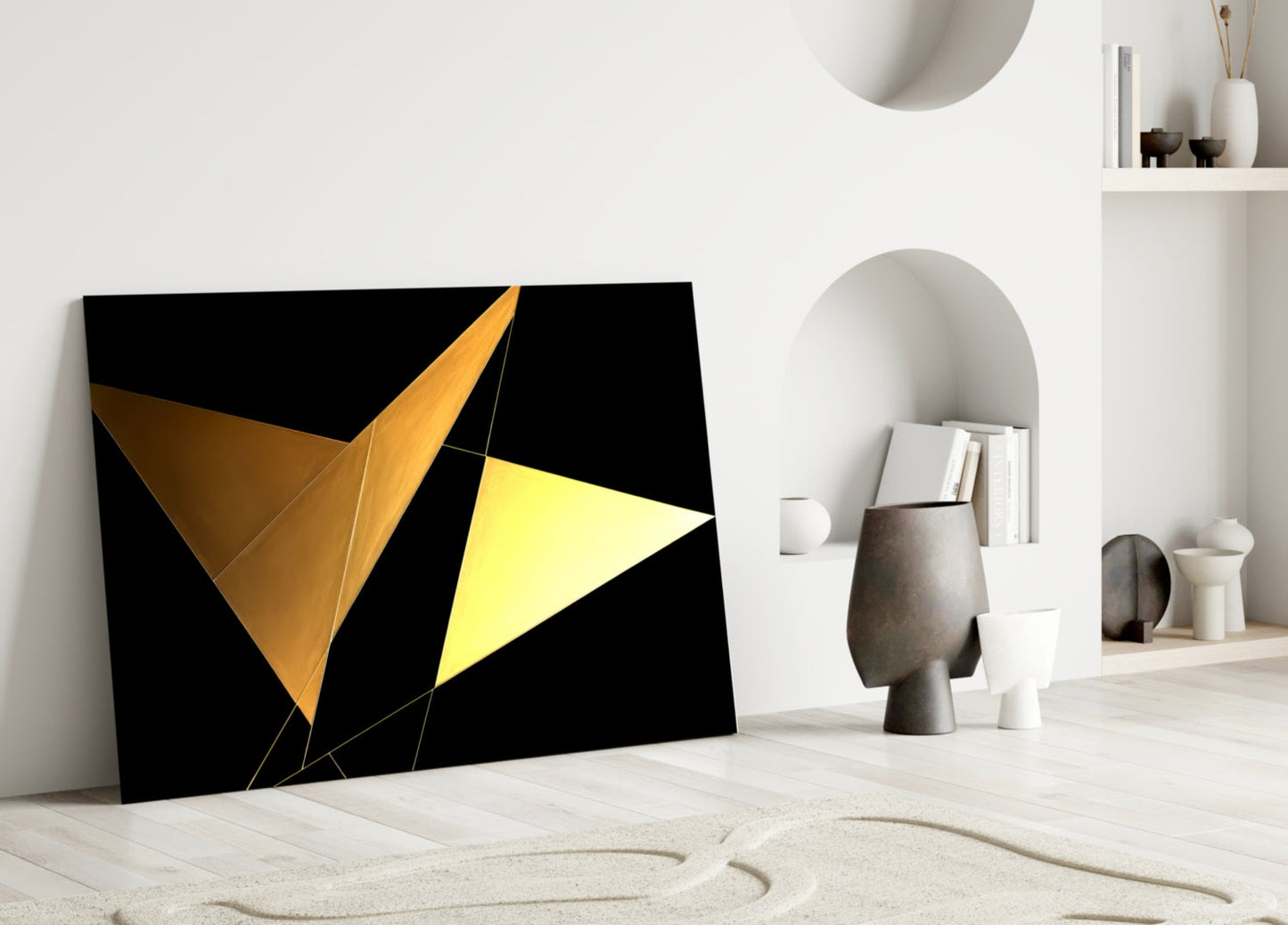 Modern interior displaying black glass wall art with yellow and gold geometric triangular shapes leaning against white wall.