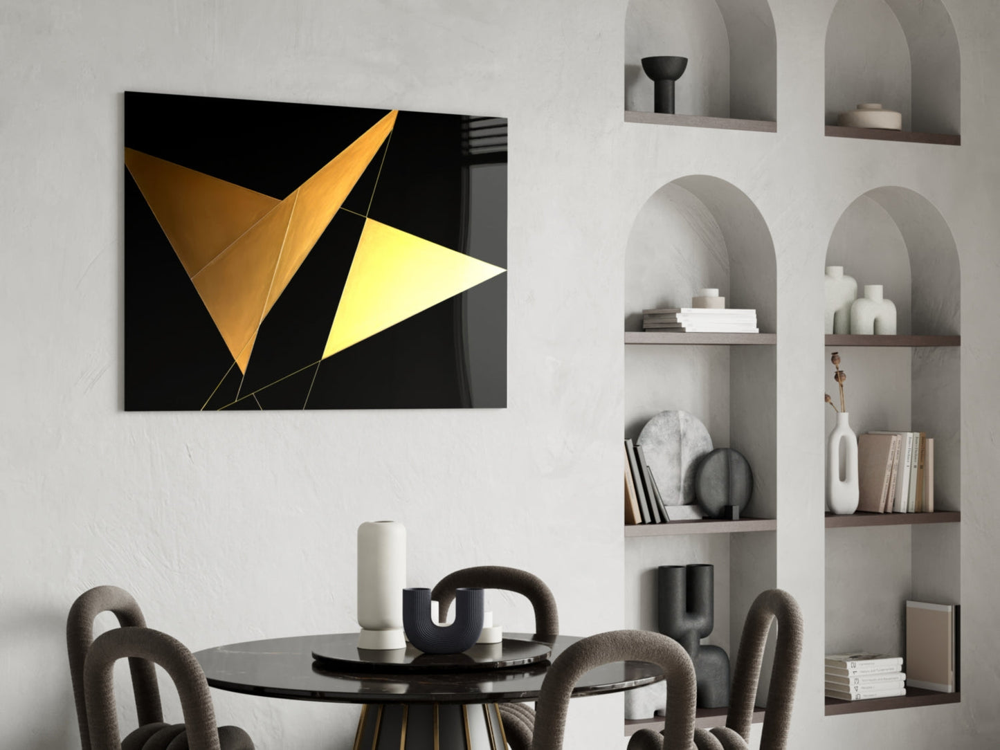Yellow Wings glass wall art with gold and yellow geometric triangles on black background, displayed above black dining table in modern interior.